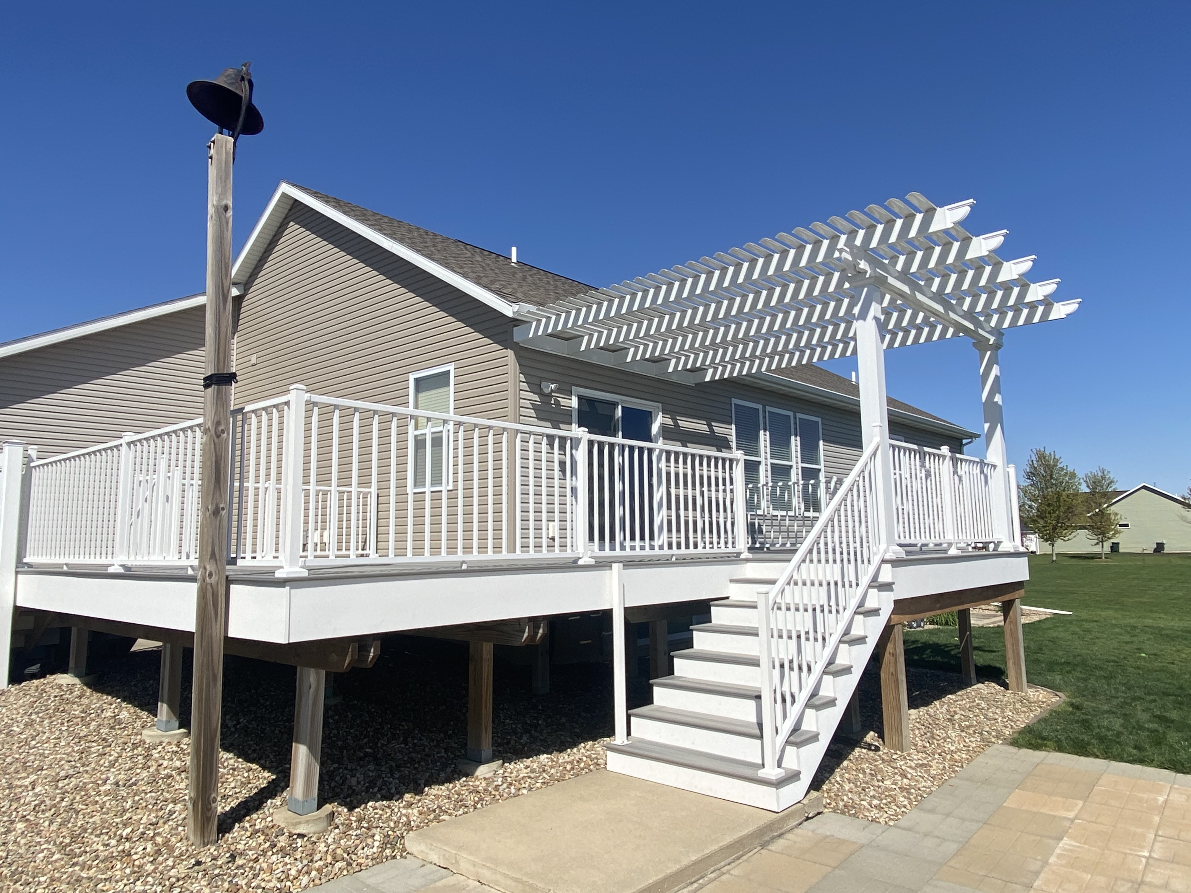 White deck with pergola and stairs