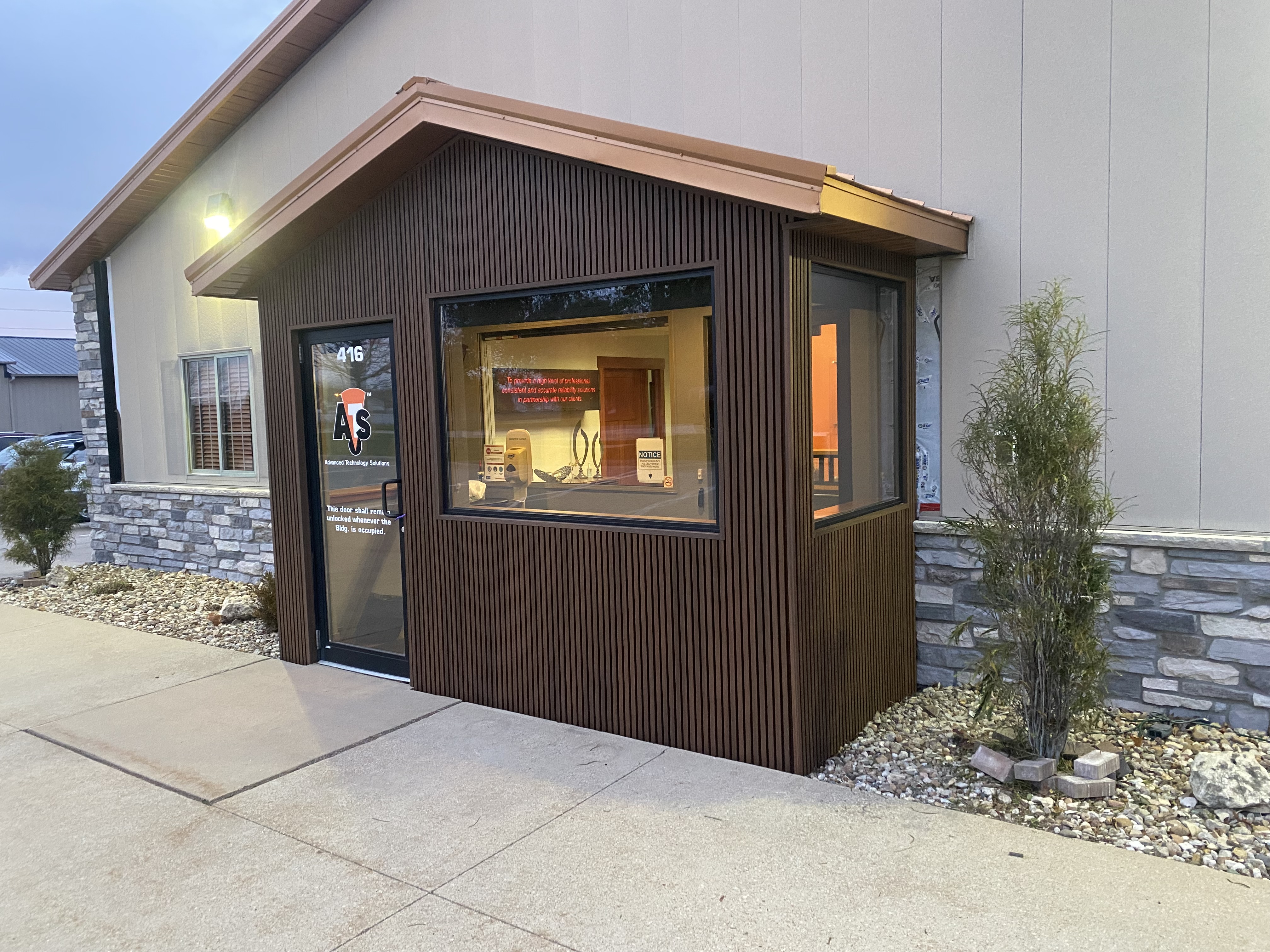 Commercial exterior with slatted wood siding and stone accents
