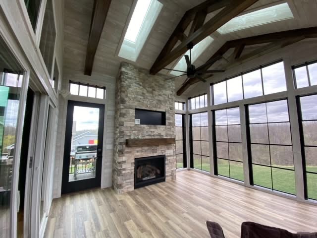 Sunroom with stone fireplace and vaulted ceiling