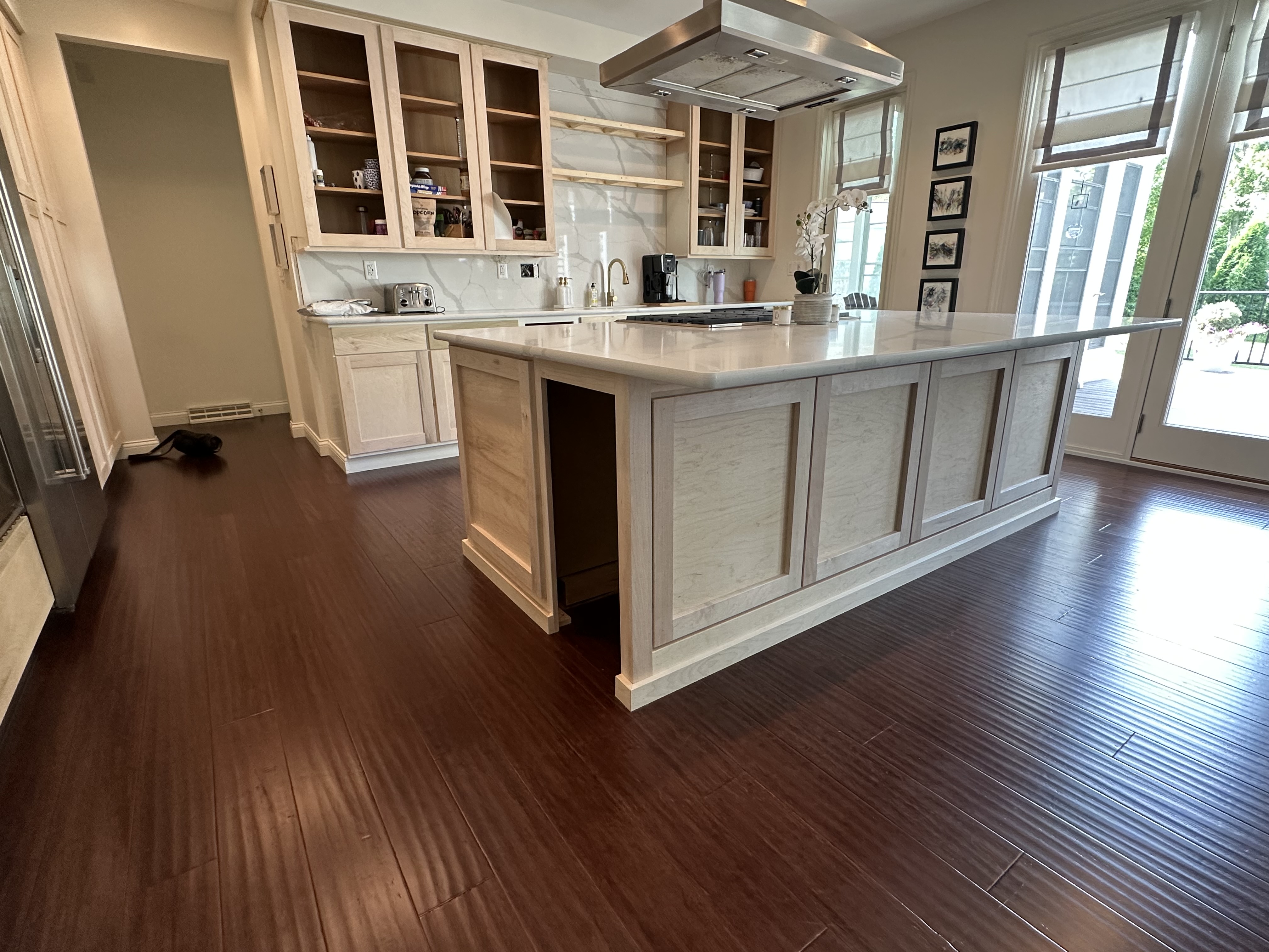 Custom kitchen with marble island and wood cabinetry